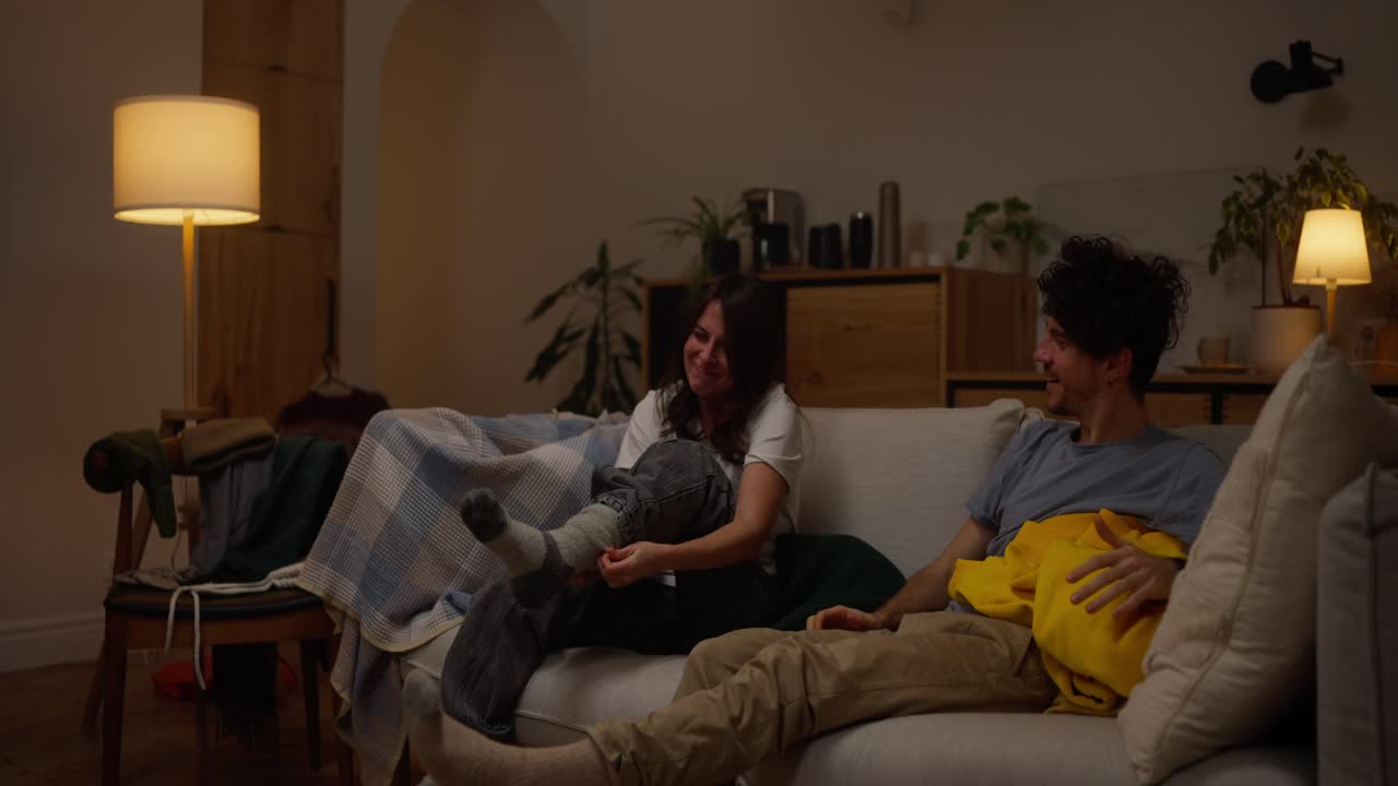 Couple Relaxing on Couch at Night