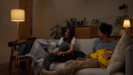 couple relaxing on couch at night
