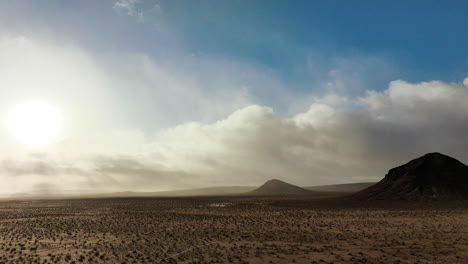 Cinematic-aerial-flyover-of-the-Mojave-Desert-with-dramatic-clouds-over-a-butte