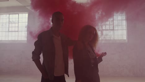 fashionable young man and woman in an abandoned warehouse