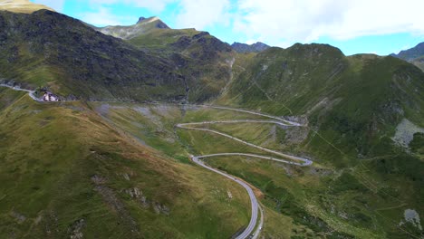 Right-to-left-trucking-pan-above-Transfagarasan-Serpentine-Road-romania,-midday-green-mountainside