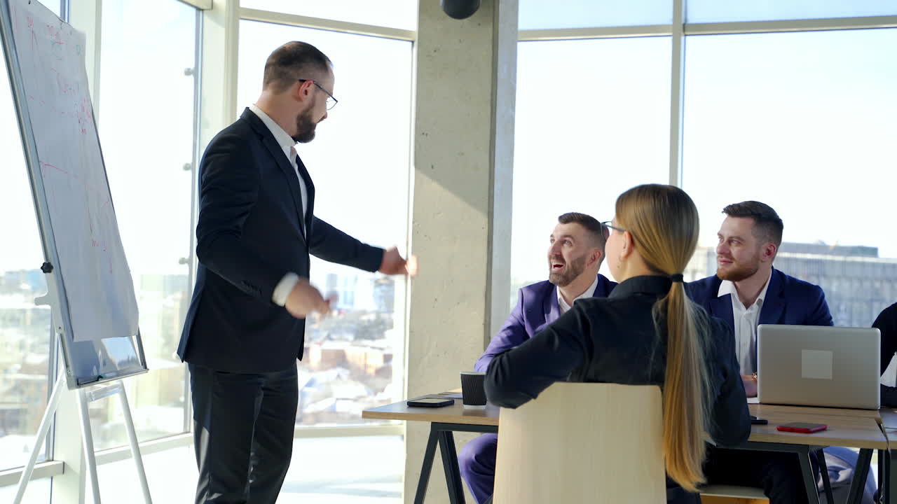 Happy business team discussing together at office meeting with laptop. Brainstorming at the office.