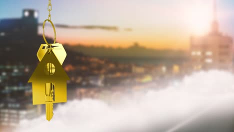 animation of golden house model with key over defocused aerial view of cityscape at sunset