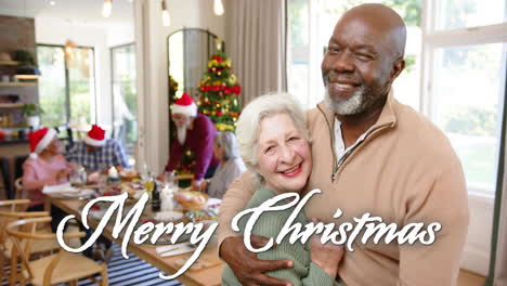 animation of merry christmas text over happy diverse senior friends celebrating christmas at home