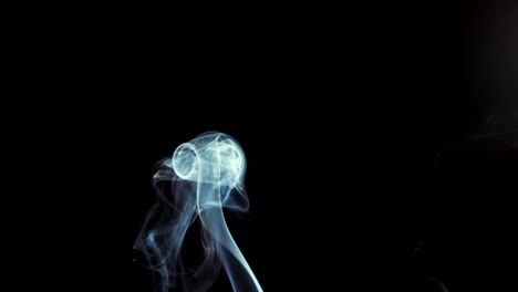 smoke rising on black background