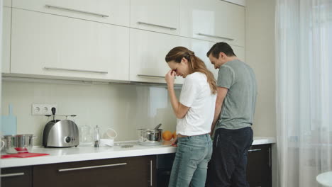 happy couple cooking together at home. man and woman having fun at kitchen.