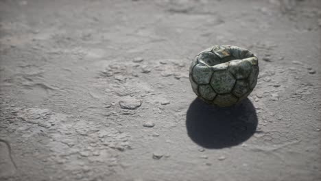 old soccer ball the cement floor