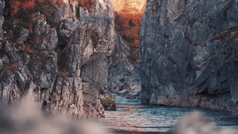 Ground-level-view-of-the-wild-river-flowing-in-the-deep-gorge-of-the-Silfar-Canyon,-Norway