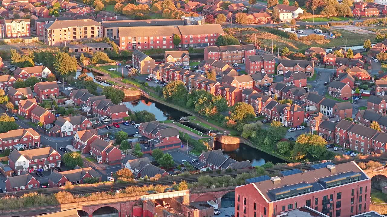Drone footage of the surrounding neighborhood and housing and canal near Everton FC’s new Bramley-Moore Dock stadium in Liverpool, England. Captured at sunset