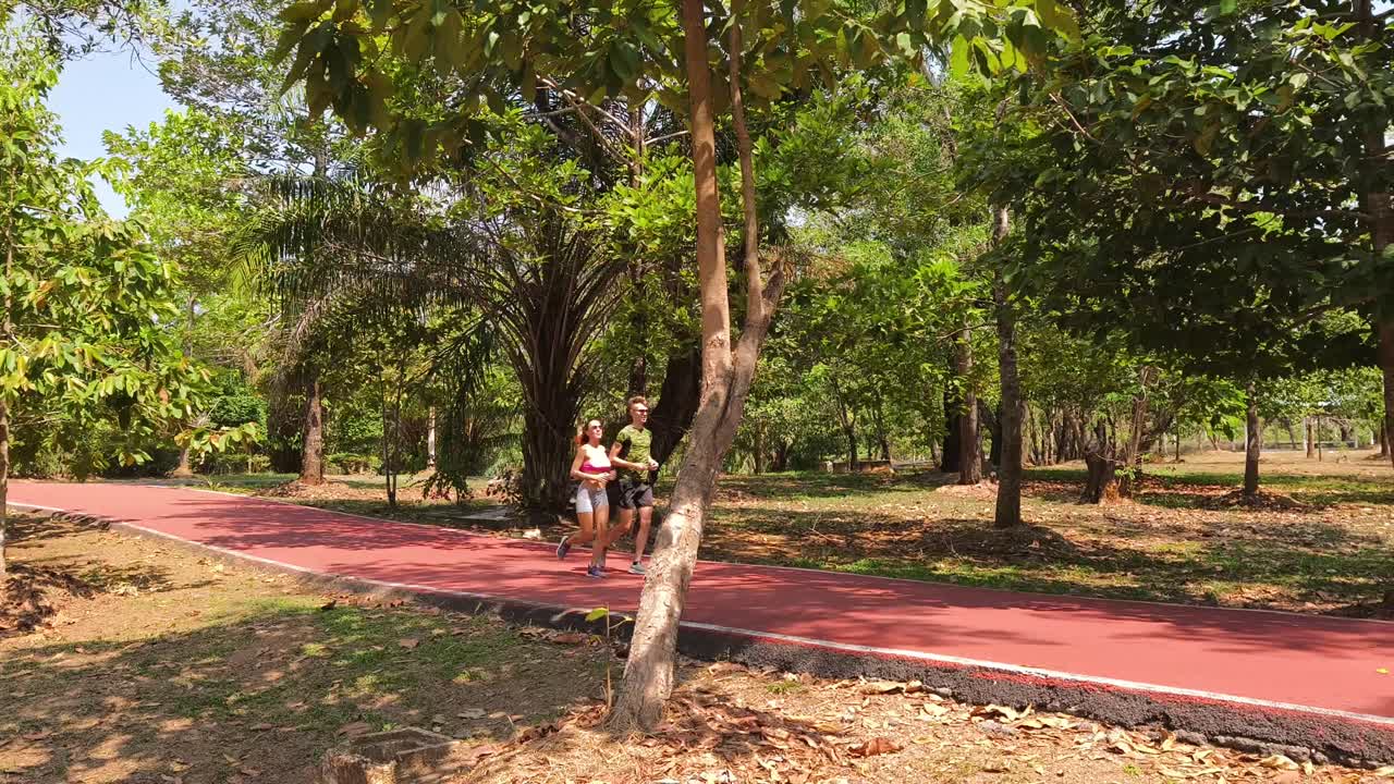 una pareja corriendo en un parque.