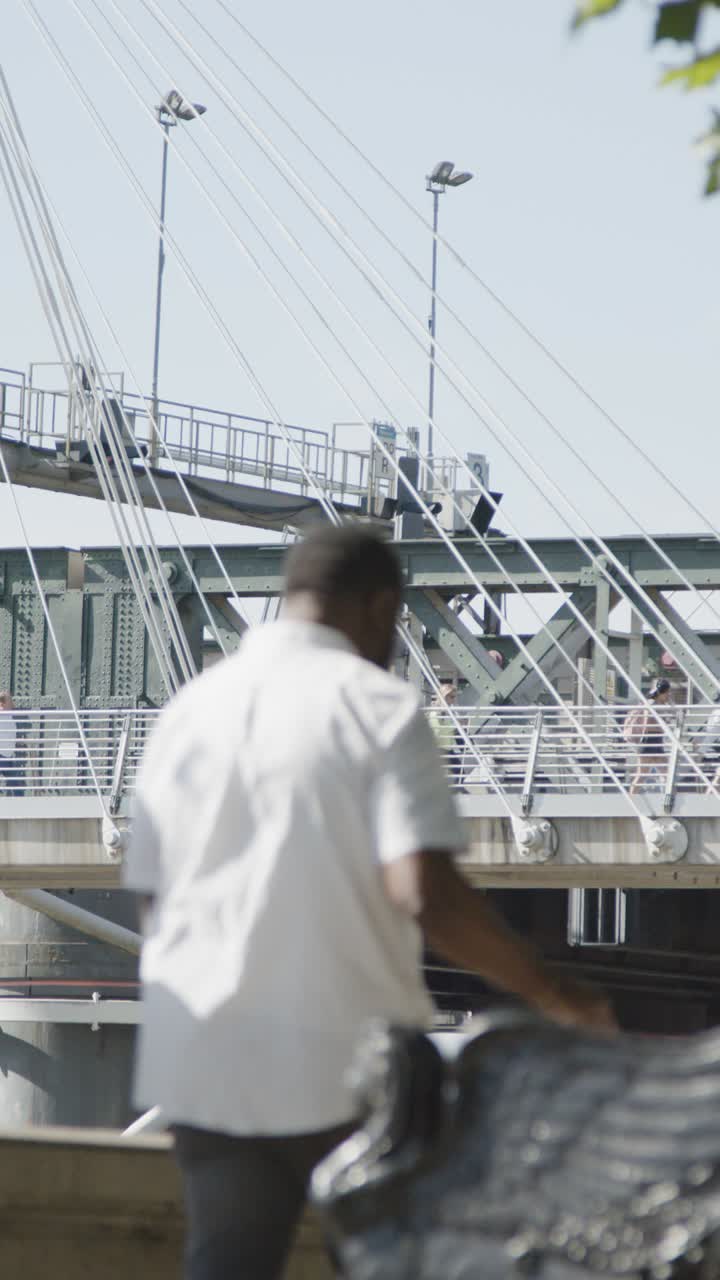Vertical Video Of Commuters Crossing Hungerford Charing Cross Bridge In London