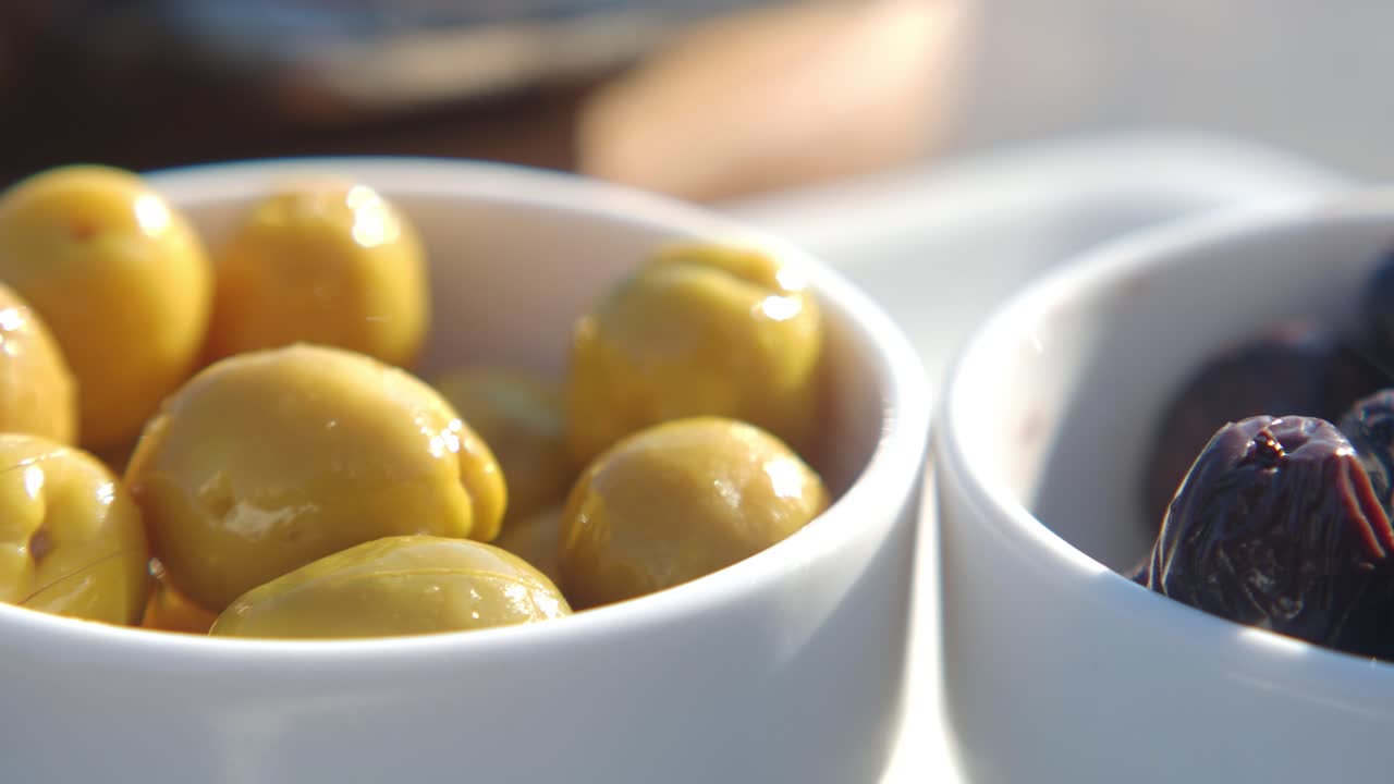 Green and Black Olives in Small Bowls