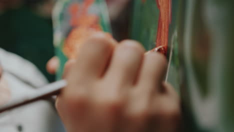 artist holding palette, painting on canvas with bold strokes