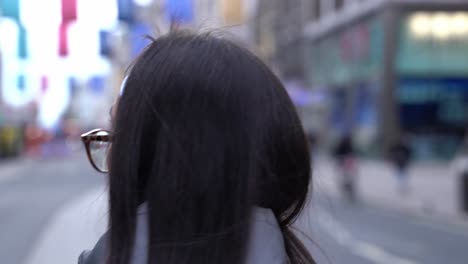 beautiful young woman walks around soho, london, close up slow motion follow cam