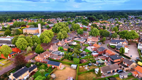 aerial view of a calm neighborhood. aerial view reveals a peaceful neighborhood with trees, homes, and open spaces in soft late afternoon light