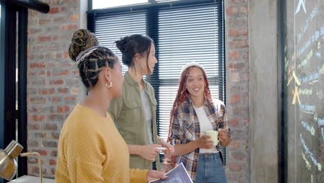 in office, diverse female team collaborating on coding project, sharing ideas enthusiastically