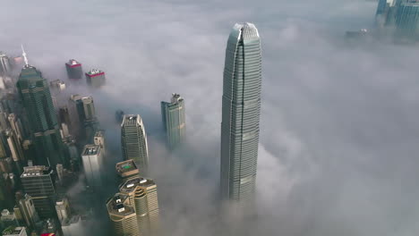 costal morning fog over international finance center and other buildings poking out of the fog