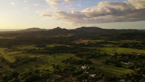 Mountainous-landscape-between-central-American-farmland-and-the-pacific-ocean-during-sunset