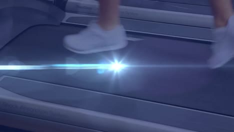 animation of legs of woman running in gym with glowing blue light moving in the foreground