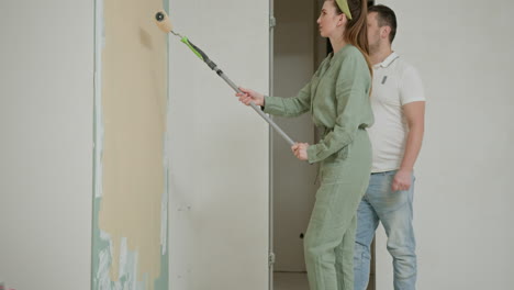 couple painting a wall in their home