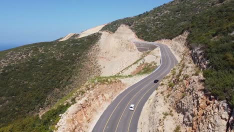 Aerial-view-of-black-and-white-cars-driving-on-the-highway