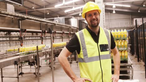 Portrait-of-worker-standing-with-hands-on-hip-in-factory