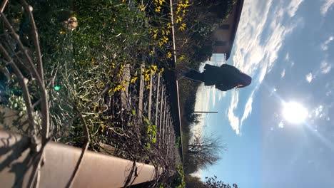 young-kid-walks-with-equilibrium-on-a-rusted-rail-track-with-industrial-background