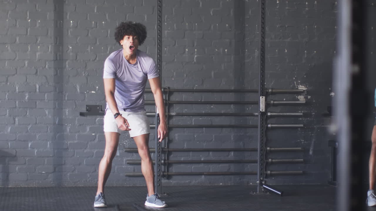 Exercising in gym, man in athletic wear taking break from workout, copy space