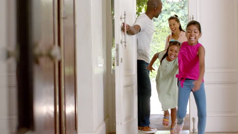 running into house, excited children entering home with parents following behind