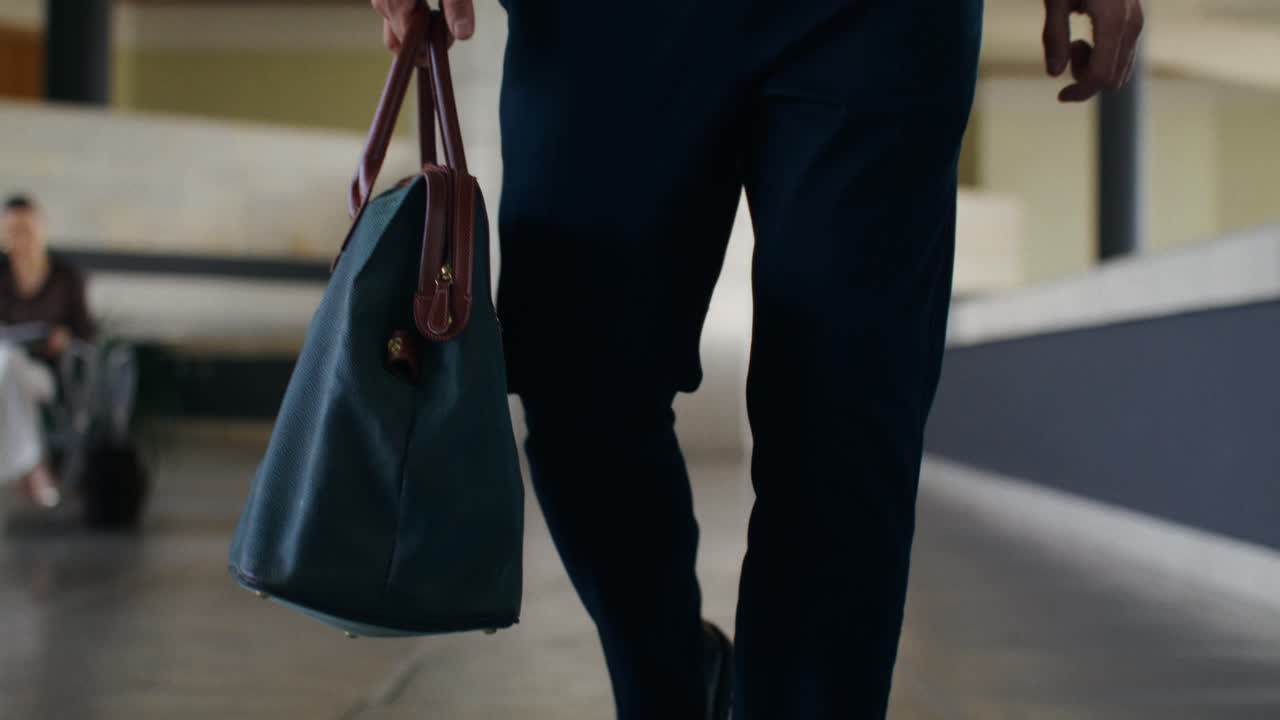 Man walking with bag in an office building