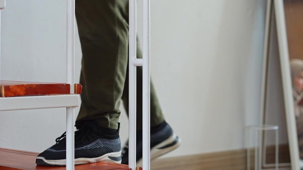 Close-up on legs person practices rapid stair climbing cardio exercises at home