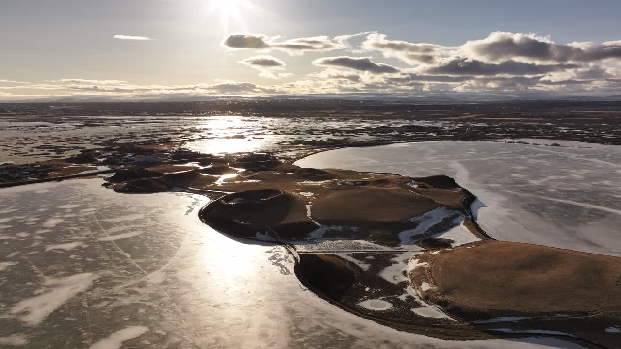 Frozen lake with volcanic craters in low winter sun at Mývatn near Reykjahlíð, Iceland