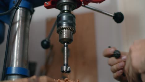 man using drill press
