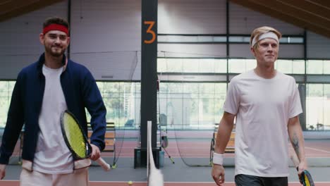 two men shaking hands after a tennis match