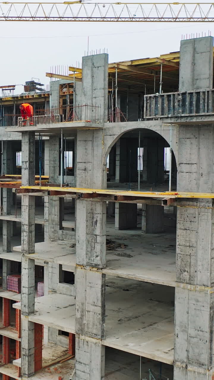 Construction of a residential apartment complex. Aerial view. Vertical video