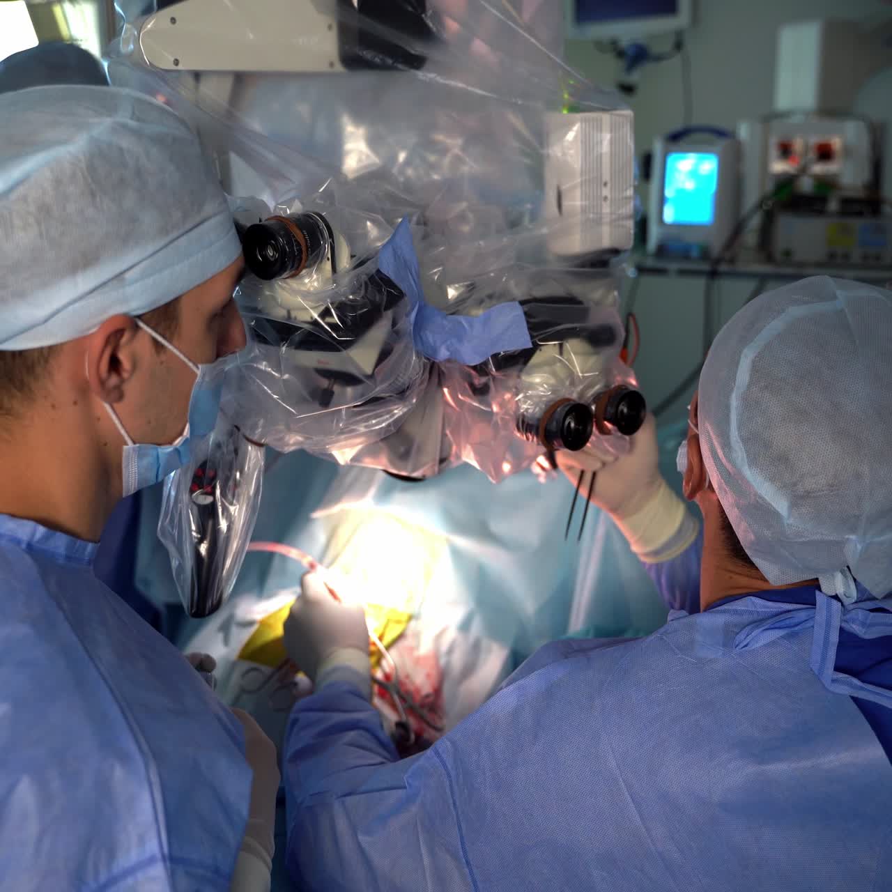 Surgeons using high-precise technological equipment for operation. Two doctors look into microscope during surgery. Close up