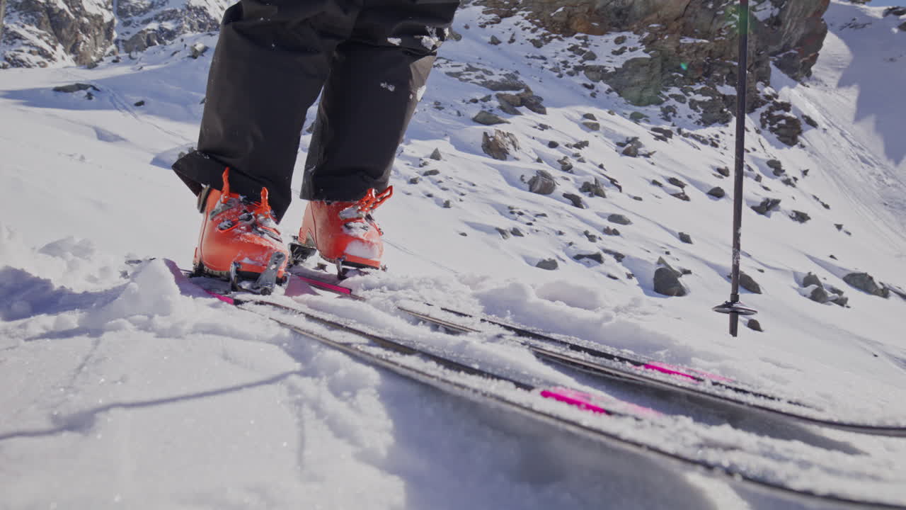A professional skier hikes up a steep ridge in Verbier, then drops into an epic freeride descent. Pure adventure skiing in deep snow, dramatic terrain, and breathtaking alpine scenery.