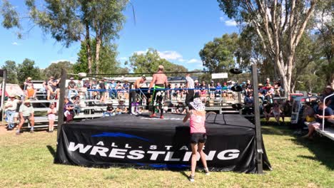 wrestlers competing in an outdoor ring