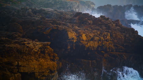 wild ocean cliff view on storm day closeup. powerful waves splashing hitting