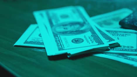 stacked banknotes on a table in a dark room