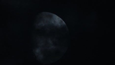 moon at night with cloud real time. 4k video moon in the black sky.  clouds passing by moon at night. night sky with cloudy weather