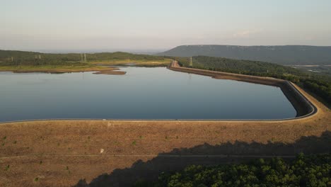 Raccoon-Mountain-Reservoir-pumped-storage-facility,-car-driving-around,-aerial-view