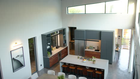 modern kitchen with island, dining table, and bar stools in contemporary home, copy space