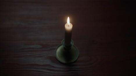 a candle burs out in the dark room
