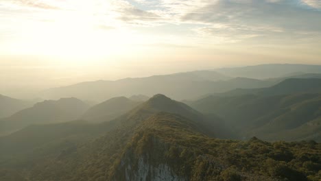 beautiful aerial view of sunrise over mountains, cinematic golden sky over mountain range