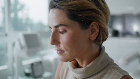 elegant woman writing papers sitting at cabinet on skincare procedures closeup.