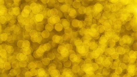 fondo de video 4k de brillo brillante abstracto. fondo de brillo dorado con textura brillante. luz brillante de oro, chispas de pañuelos y fondo de aluminio brillante.