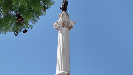 majestic column of pedro iv under blue sky in lisbon portugal