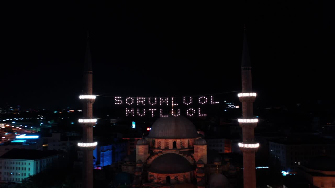 Aerial night view of New Mosque. There says " be responsible, be happy"