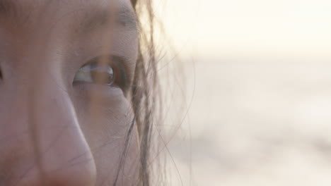 close-up-eyes-beautiful-asian-woman-contemplating-future-enjoying-mindfulness-relaxing-on-peaceful-beach-at-sunset